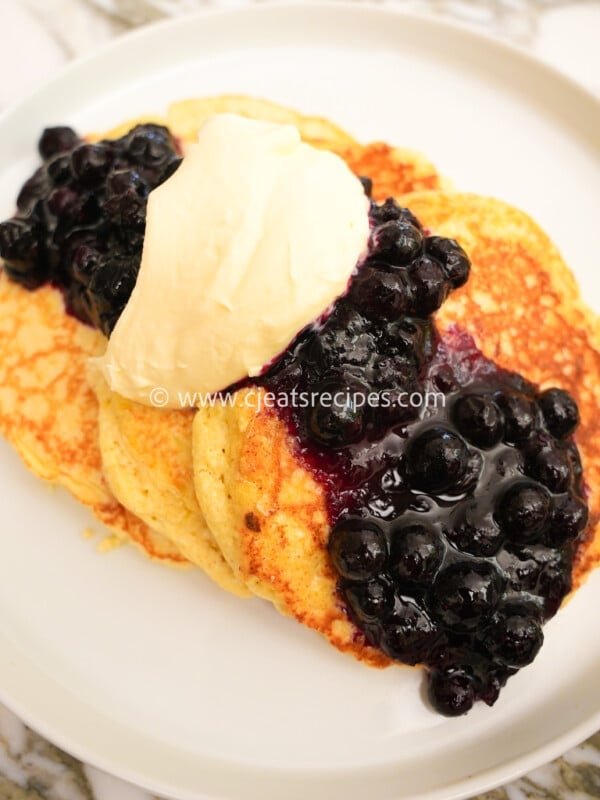 Lemon Ricotta Pancakes with Blueberry compote on a plate
