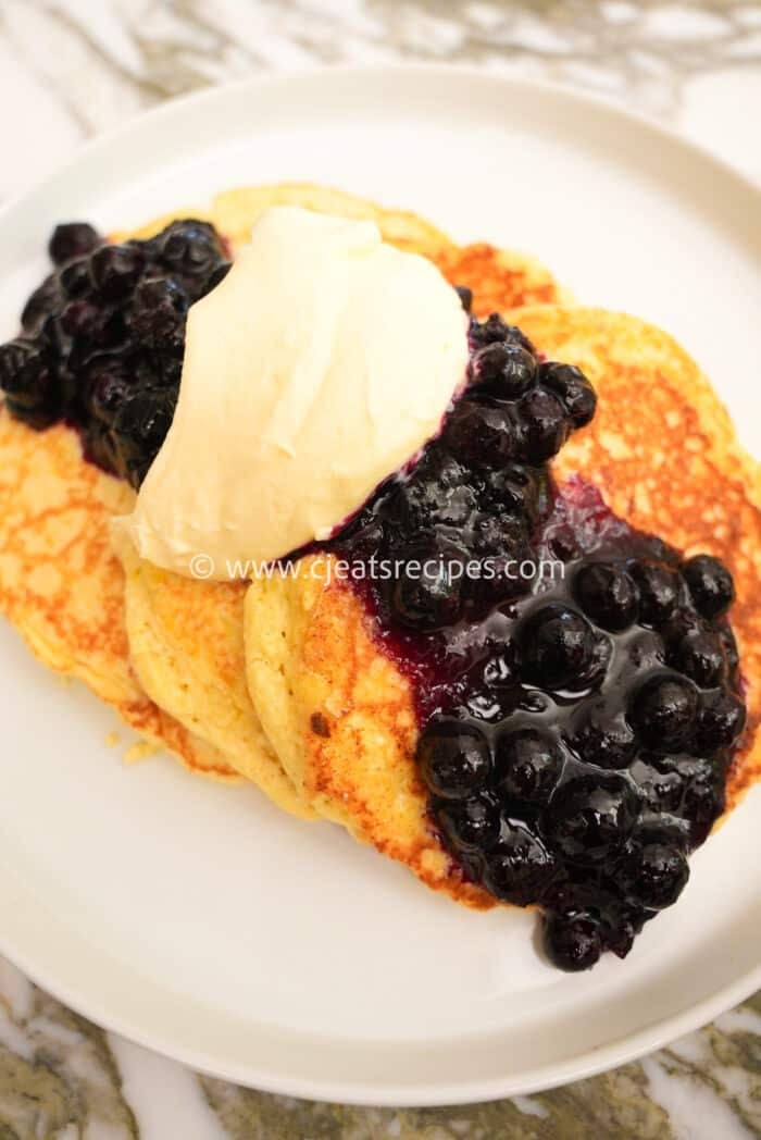 Lemon Ricotta Pancakes with Blueberry compote on a plate