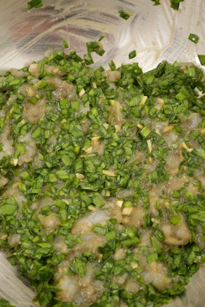 Shrimp and chive dumpling filling mixed in a bowl