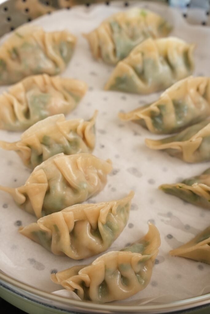 Shrimp and chive dumplings steamed in a pan.