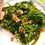 Spicy korean spinach side dish on a small plate.
