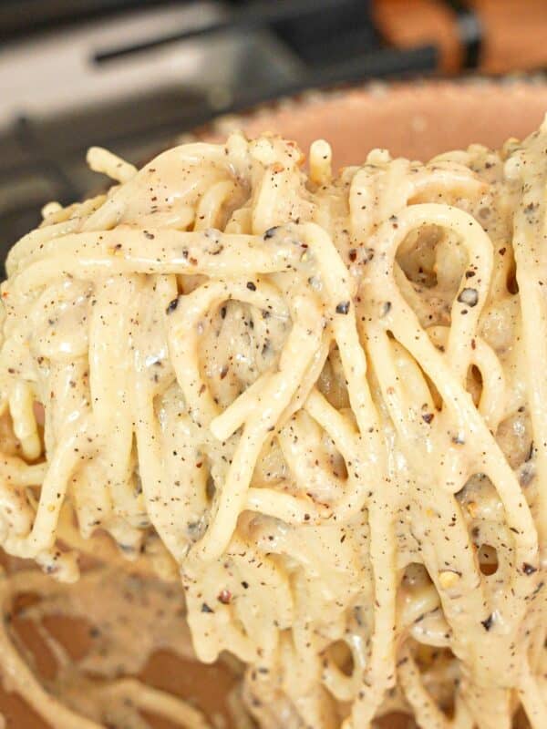 An authentic, creamy Cacio e Pepe with pasta, pecorino romano cheese, black peppercorns, and pasta water.