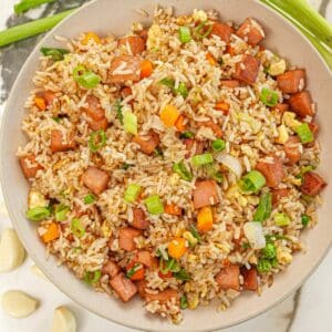 Spam Fried Rice in a bowl with vegetables, garlic, spam and scallions.
