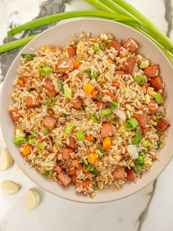 Spam Fried Rice in a bowl with vegetables, garlic, spam and scallions.