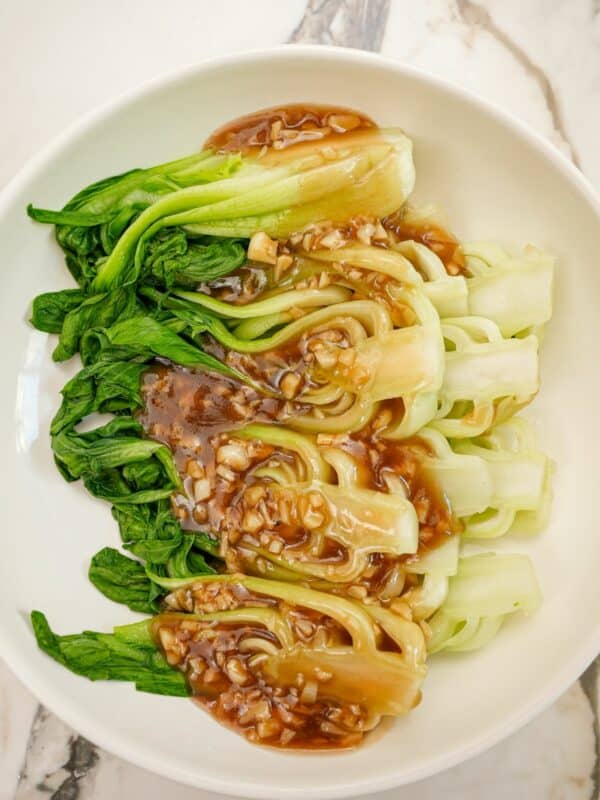 A bowl of bok choy with garlic sauce.