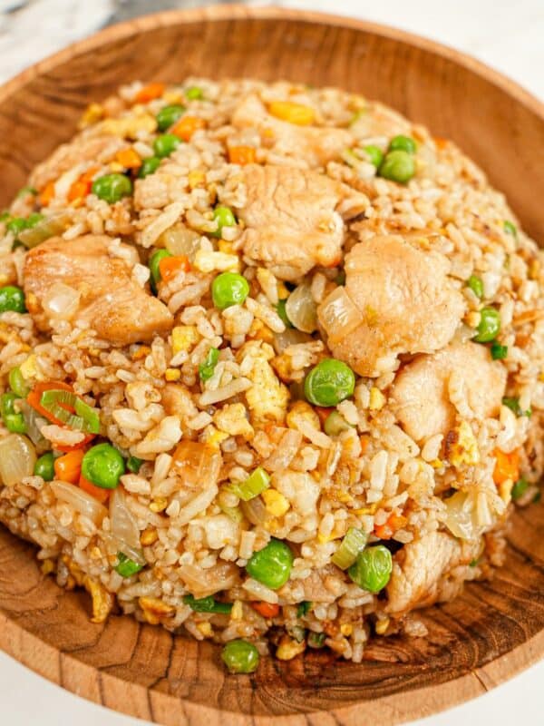 Chicken fried rice in a wooden bowl.