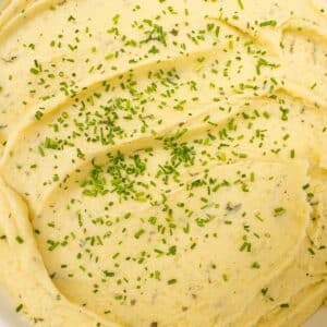 Creamy mashed potatoes in a bowl with chives.