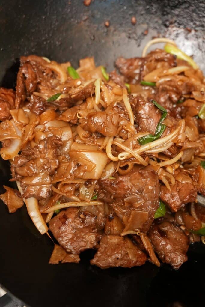 Beef Chow Fun noodles cooked in a wok.
