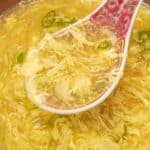 Egg Drop soup in a bowl with a spoon.