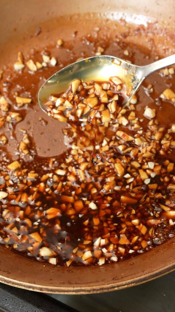 The honey garlic glazed being thickened in the pan.