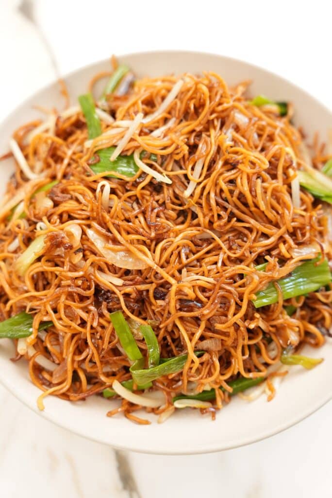 A close up photo of the pan fried noodles in a bowl.