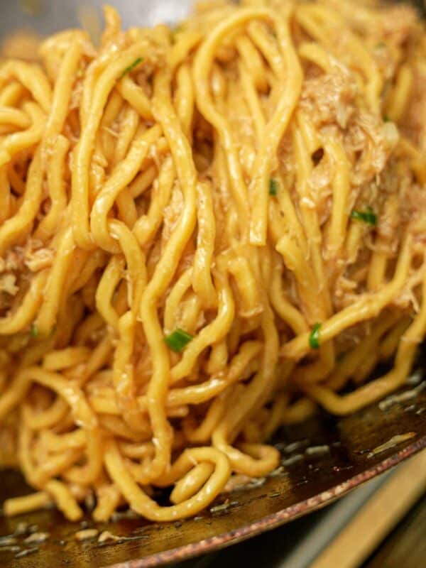 Garlic Noodles with crab cooked in a wok.