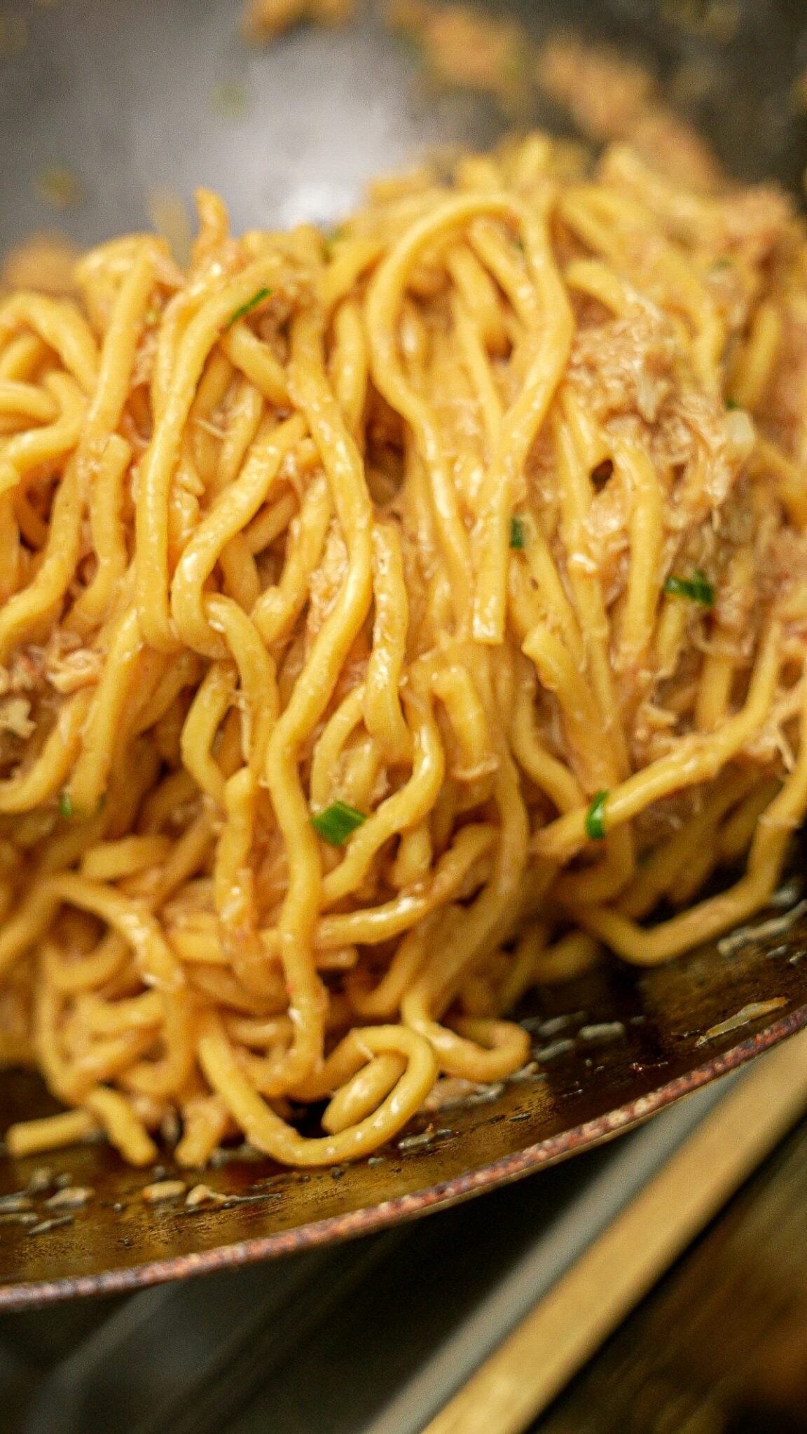 Garlic Noodles with crab cooked in a wok.