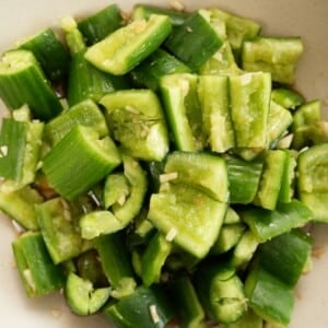 Chinese smashed cucumber salad plated in a round bowl.