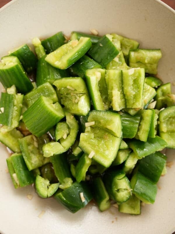 Chinese smashed cucumber salad plated in a round bowl.