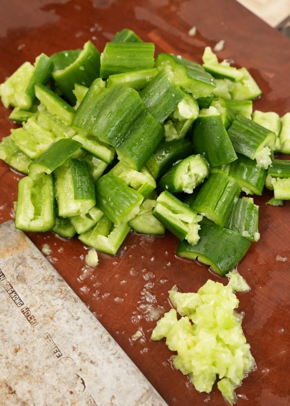 Cucumbers smashed on a cutting board.