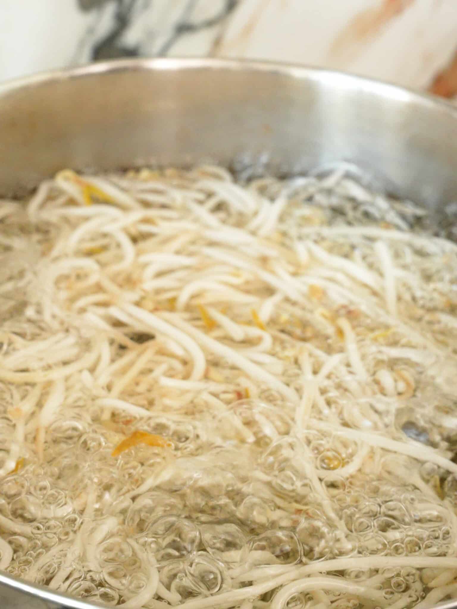Bean Sprouts being blanched in boiling water.