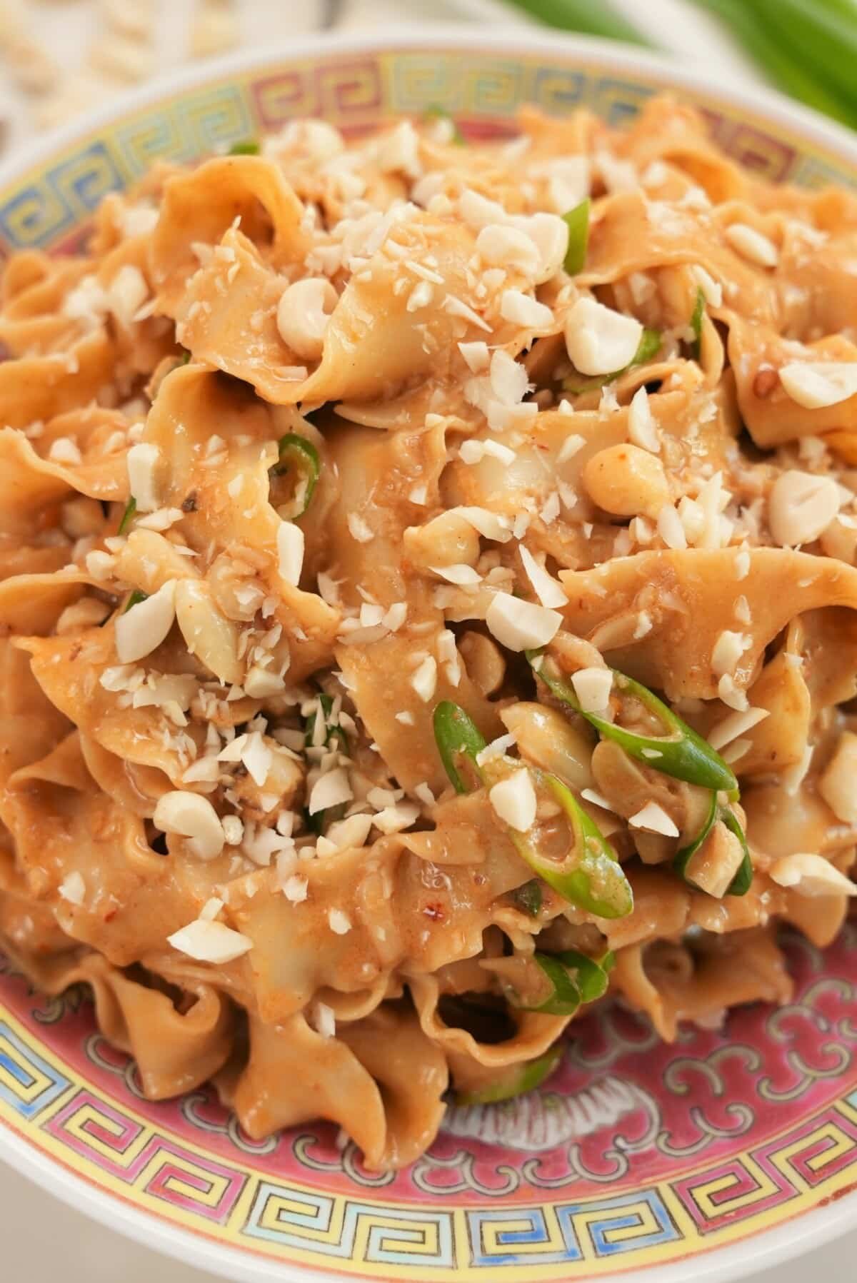 Sesame Peanut Noodles topped with crushed peanuts.