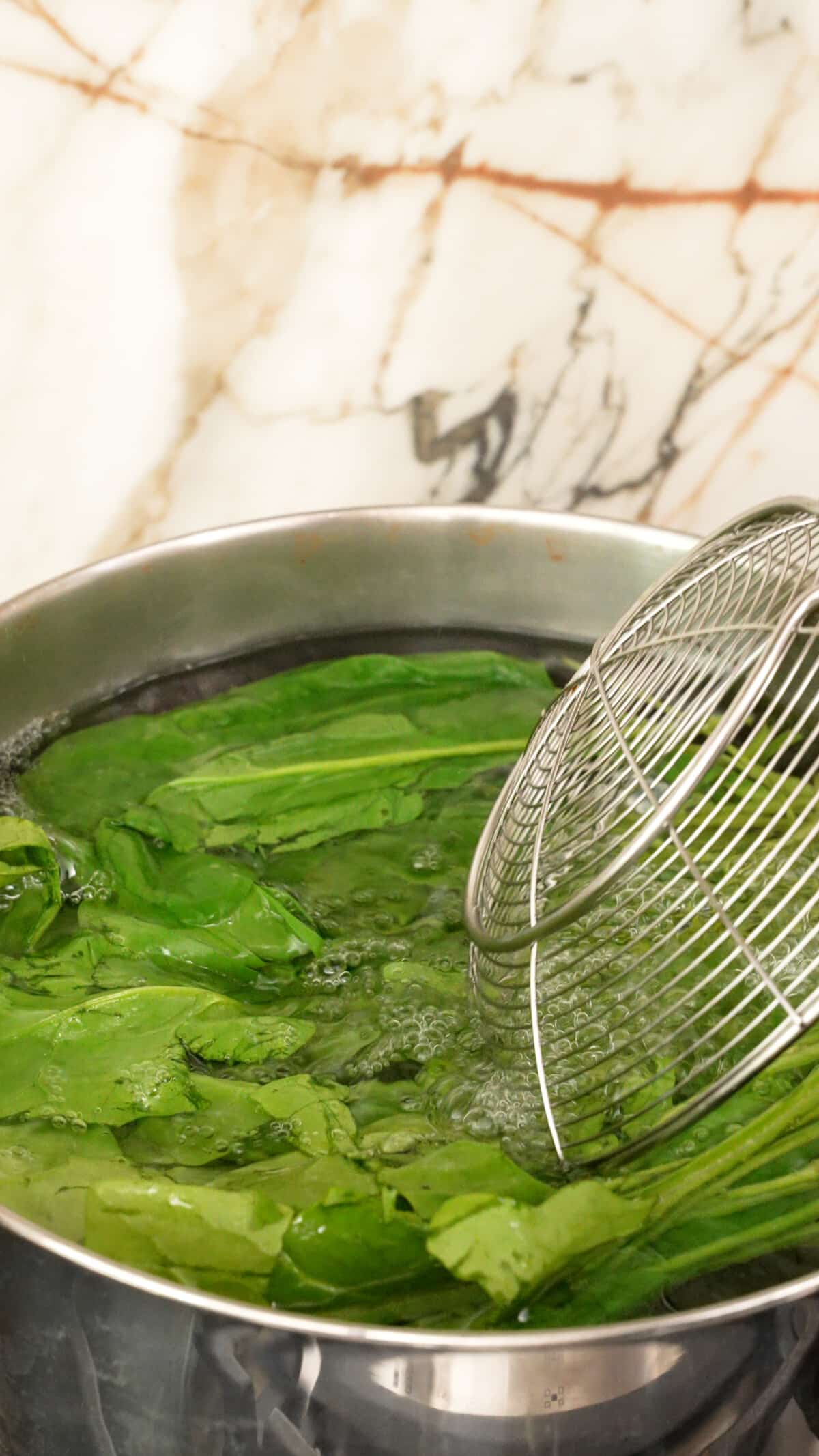 Spinach blanching in boiling water.