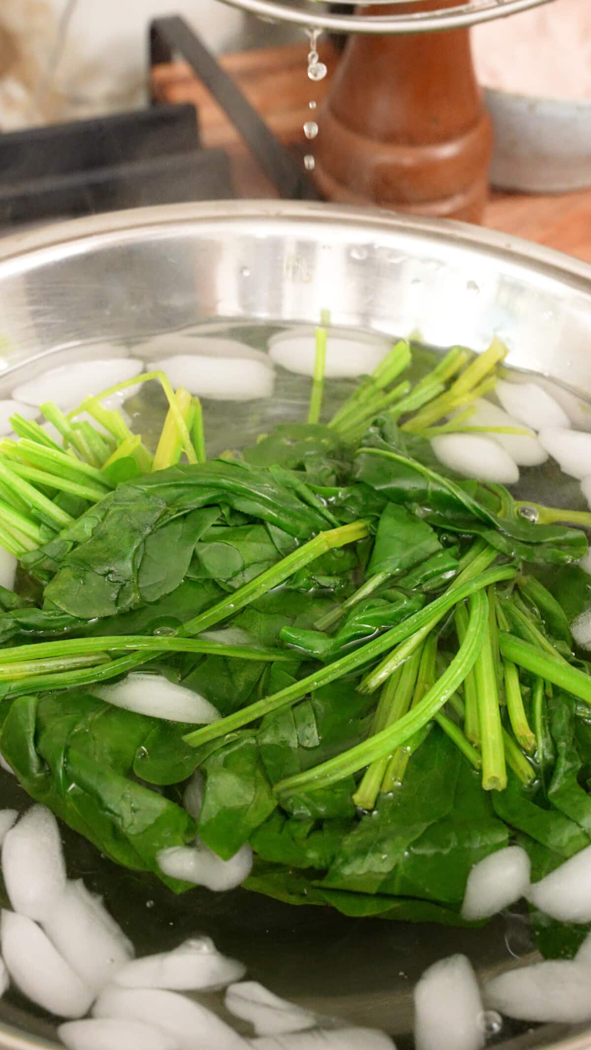 Spinach cooling down in an ice bath.