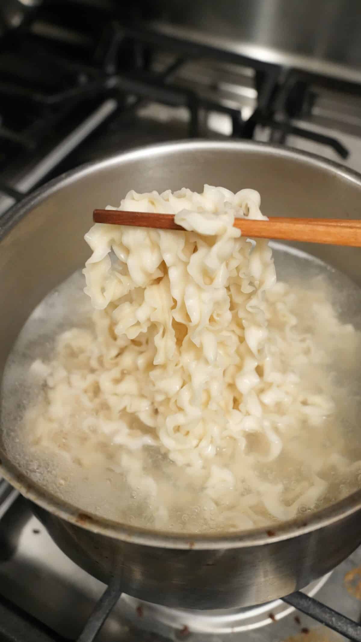 Knife cut wheat noodles cooked in boiling water.