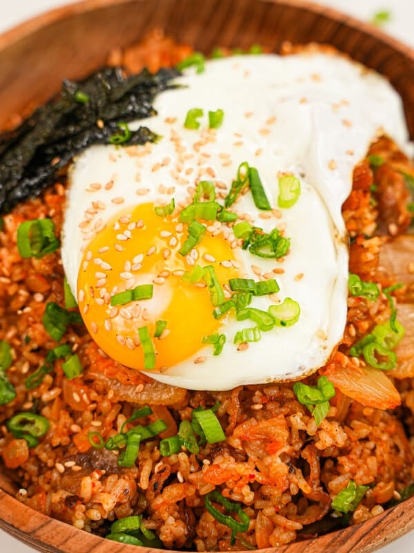 Kimchi Fried Rice on a bowl topped with scallions and a fried egg.