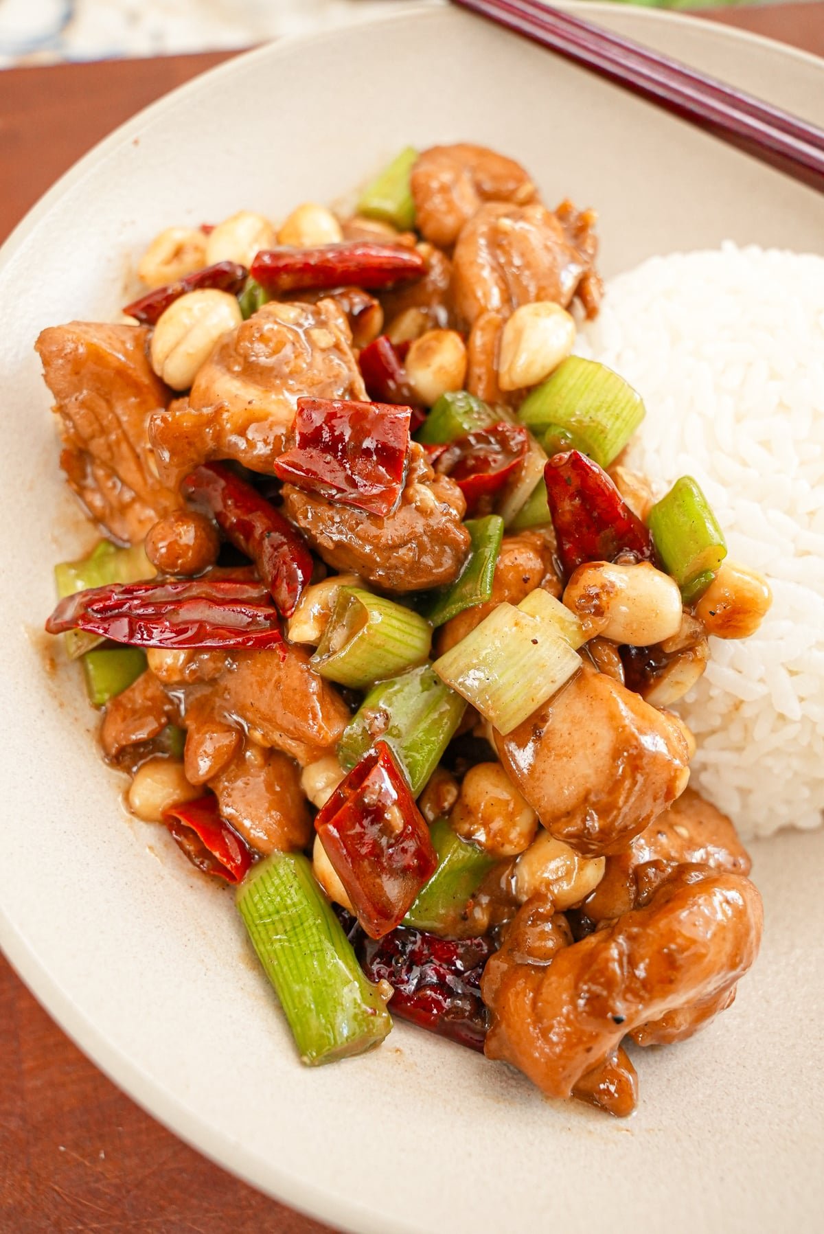 Kung Pao Chicken on a plate with a side of white rice.