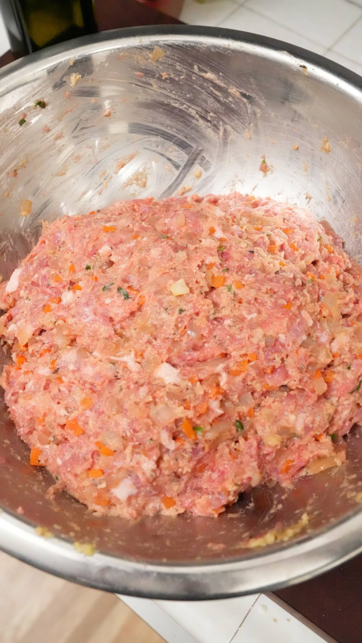 The meatloaf mixture mixed in a metal bowl.