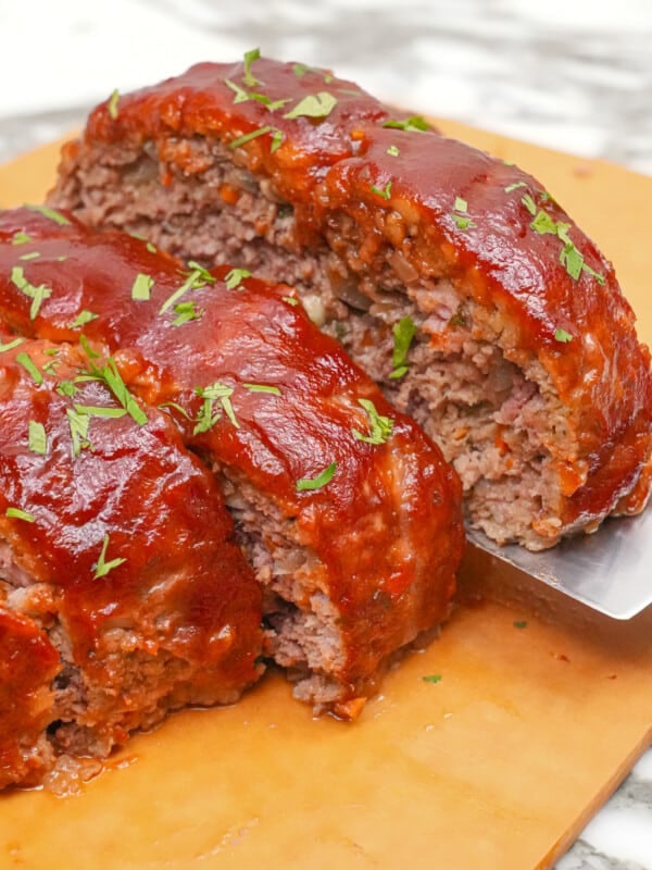 Meatloaf sliced on a cutting board.