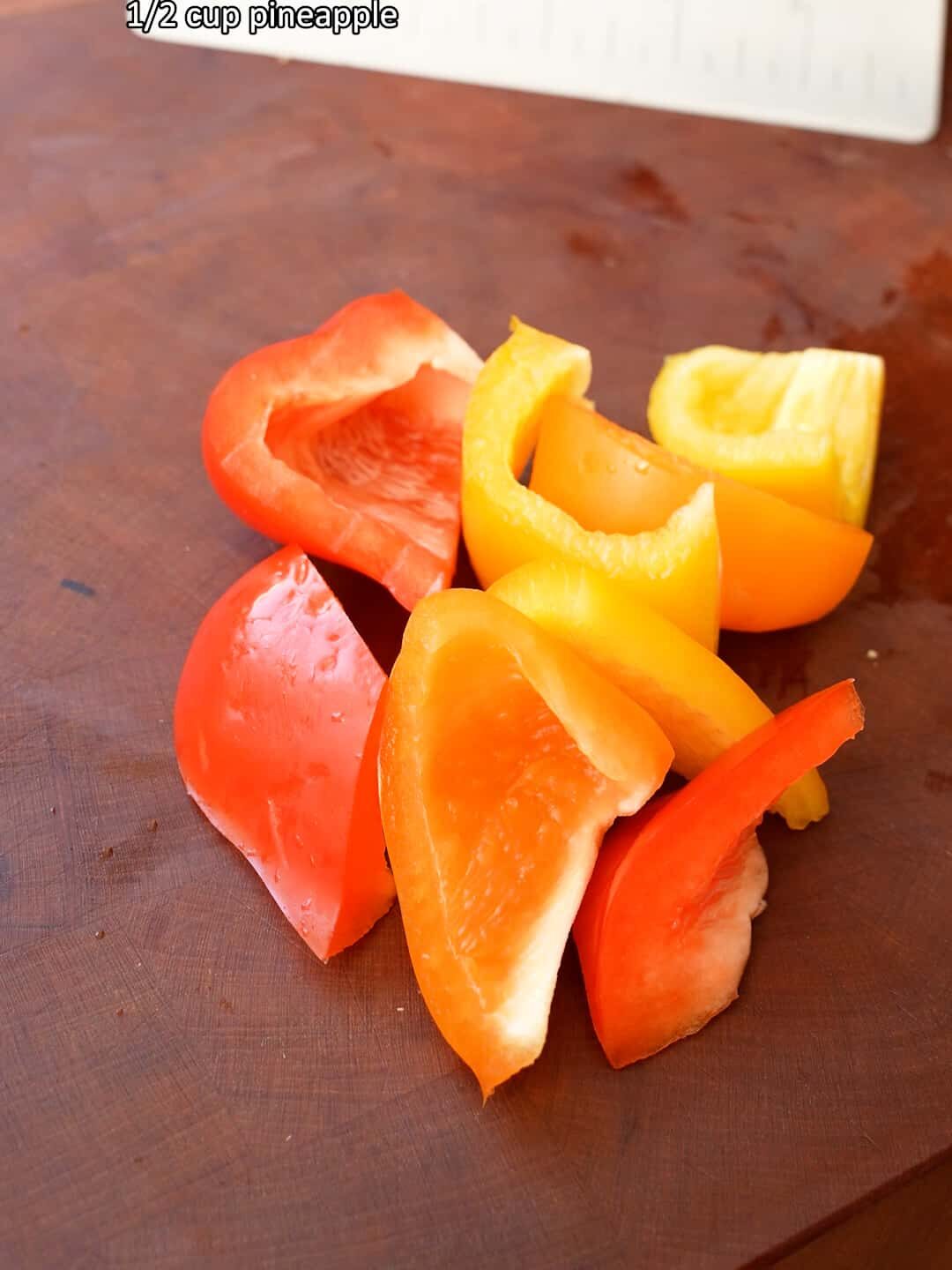 Cut pieces of bell pepper on a cutting board.
