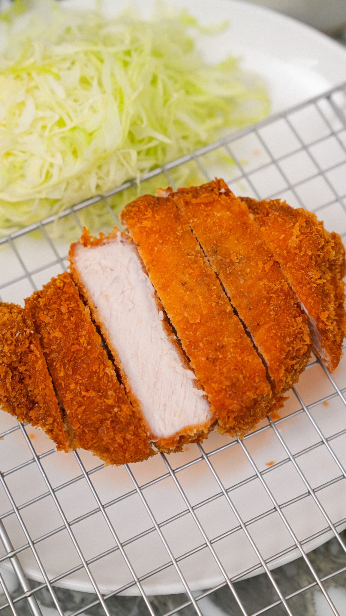 Tonkatsu on a plate with shredded cabbage.