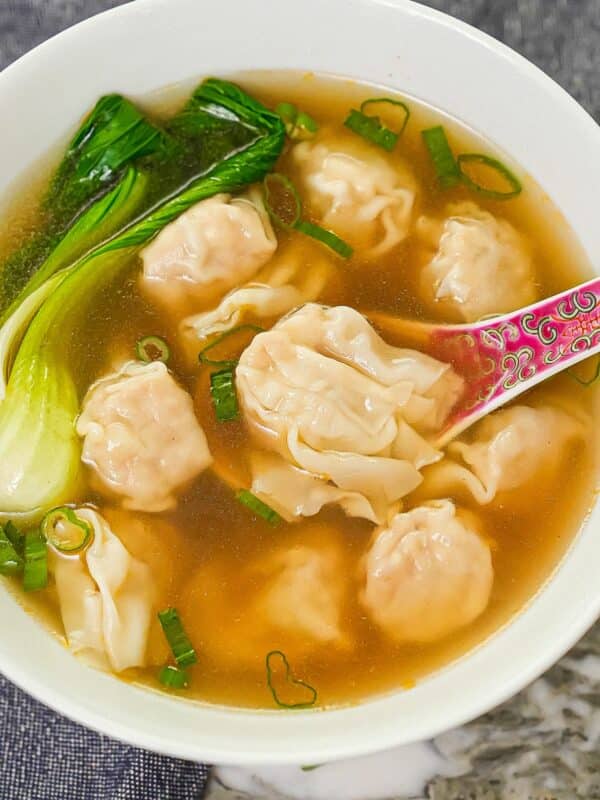 A bowl of authentic easy wonton soup with bok choy and wontons.