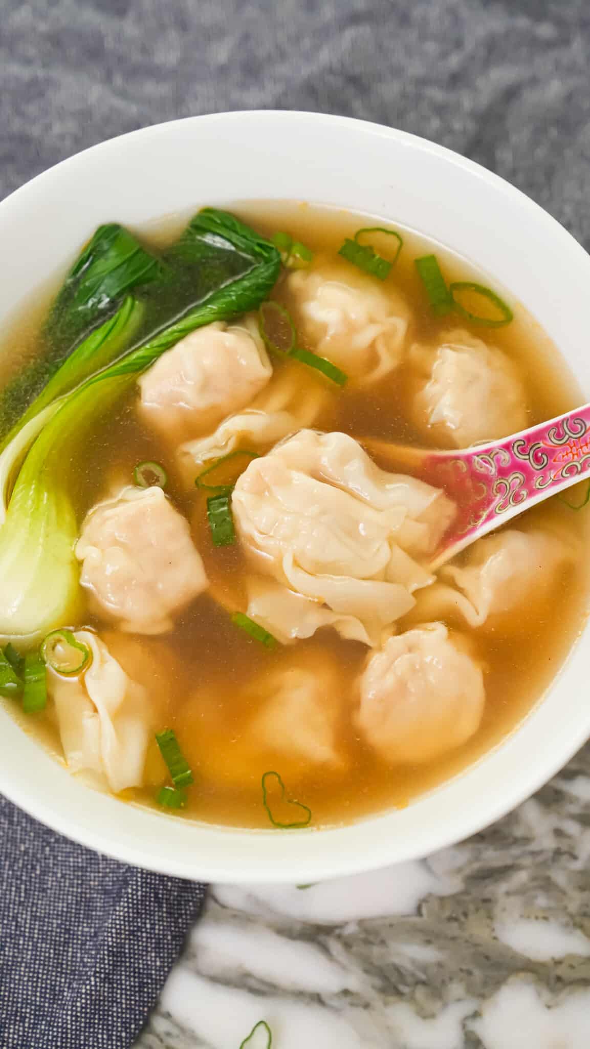 Wonton Soup in a bowl with bok choy.