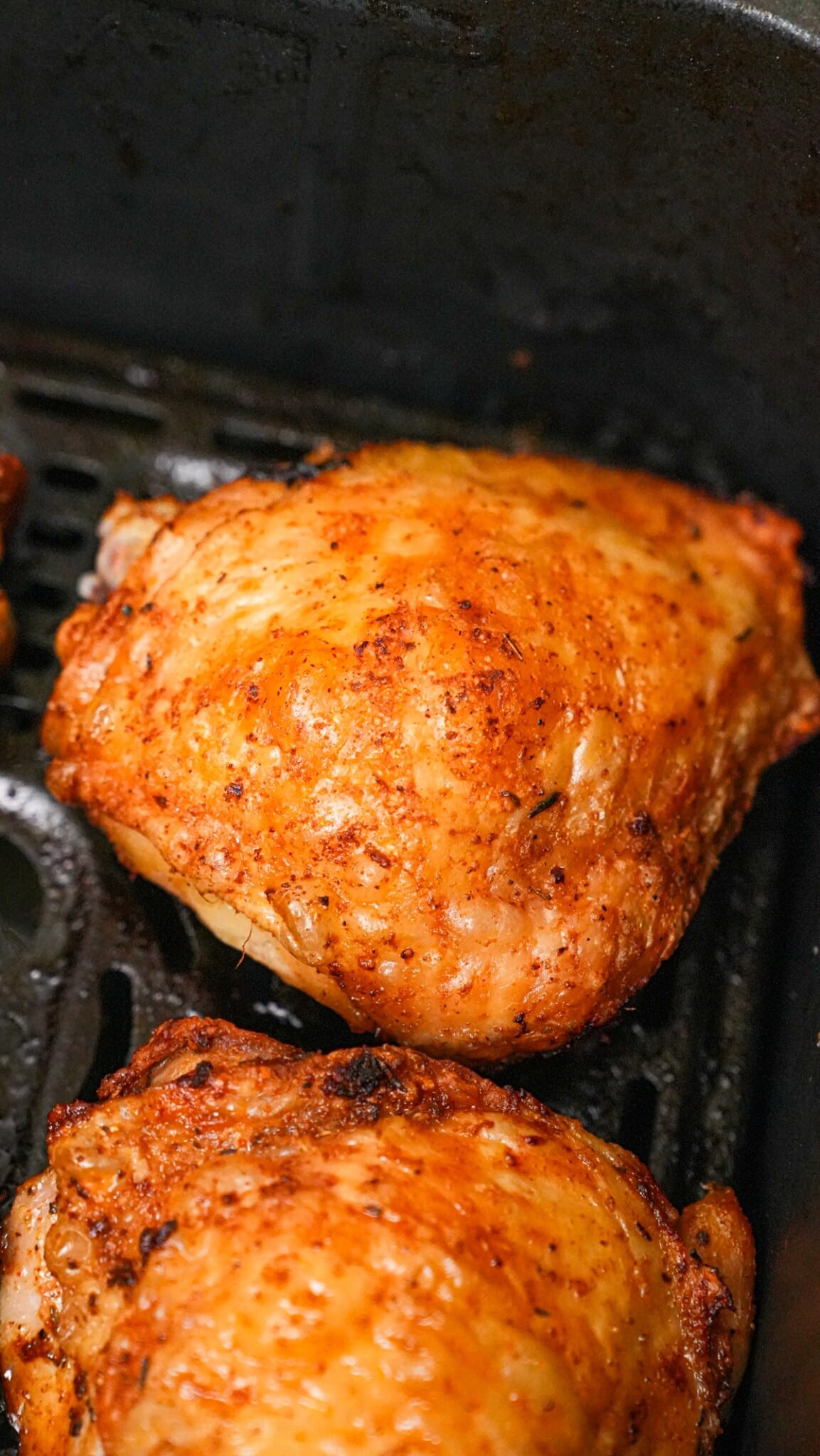 A crispy cooked chicken thigh in the air fryer.