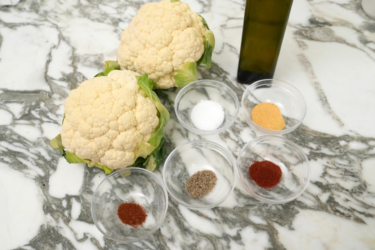 Raw ingredients for Roasted Cauliflower on a table.