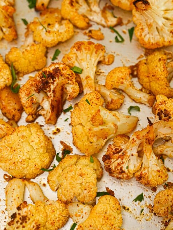 Crispy Roasted Cauliflower on a baking sheet with herbs.