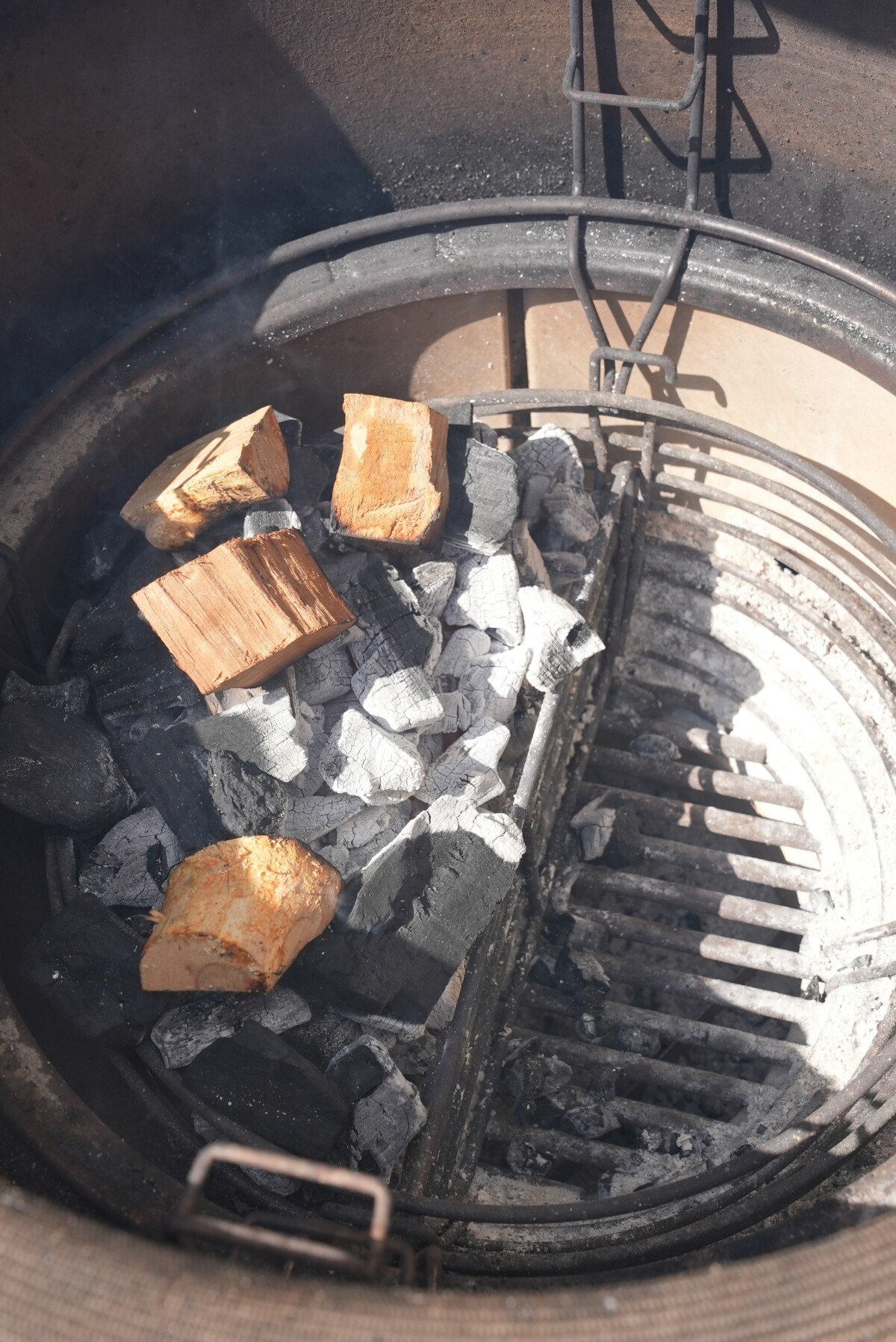 Charcoal on one side of the grill with cherry wood on top to create a direct and indirect heat zone.