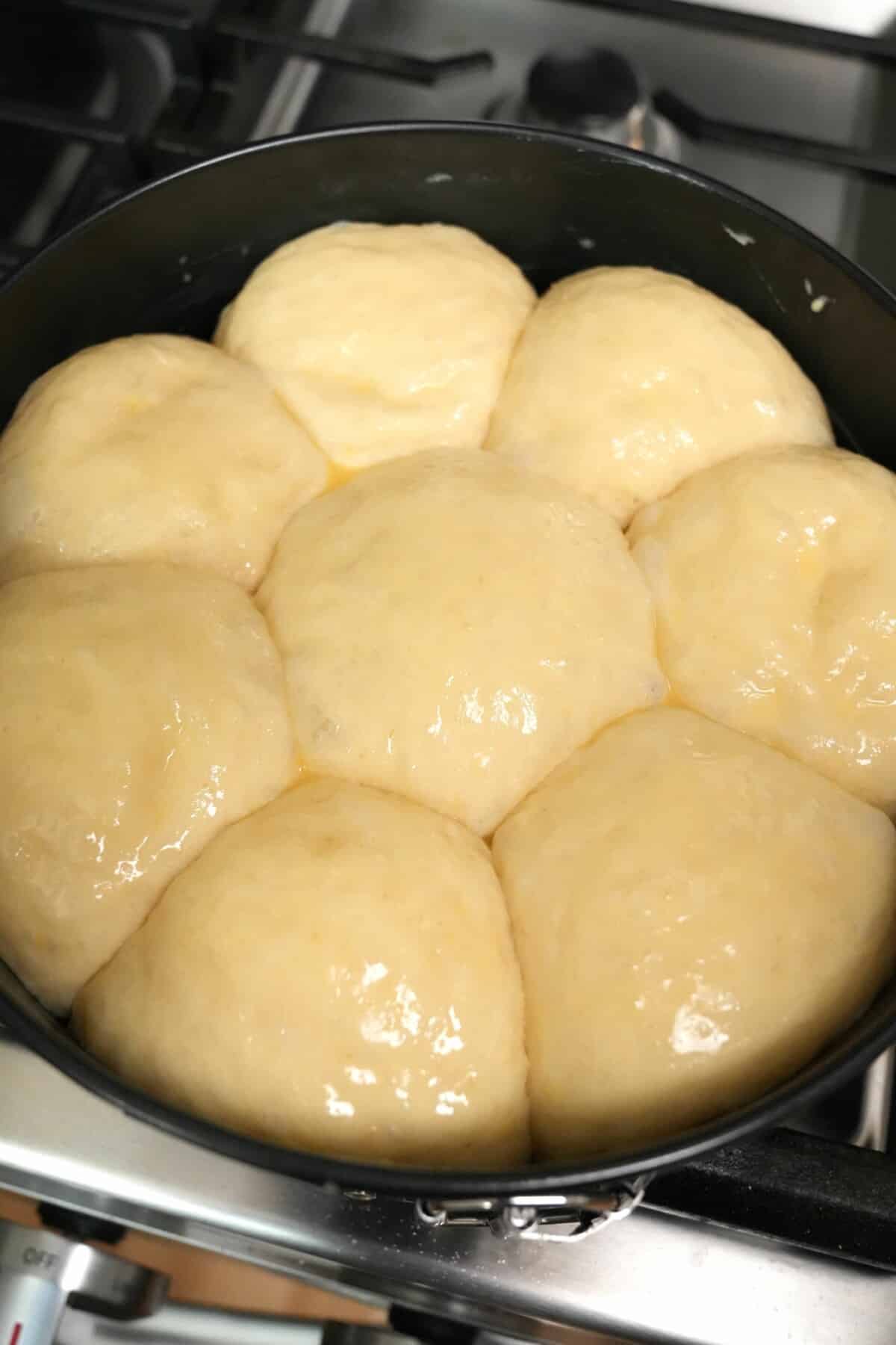 Milk Bread rolls proofed in a baking tin.