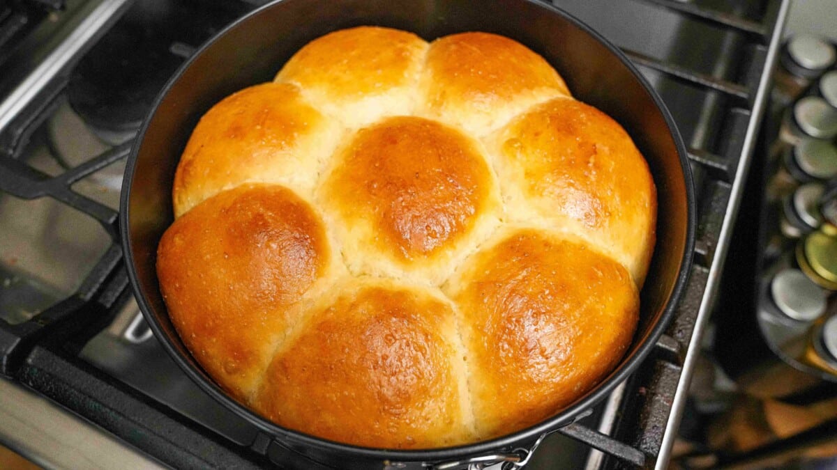 Milk bread baking and cooling on the stove.