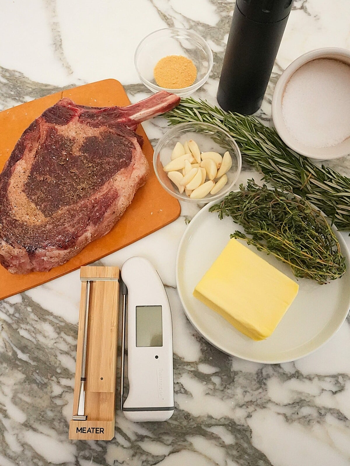 Raw ingredients for perfect grilled steak on a table.