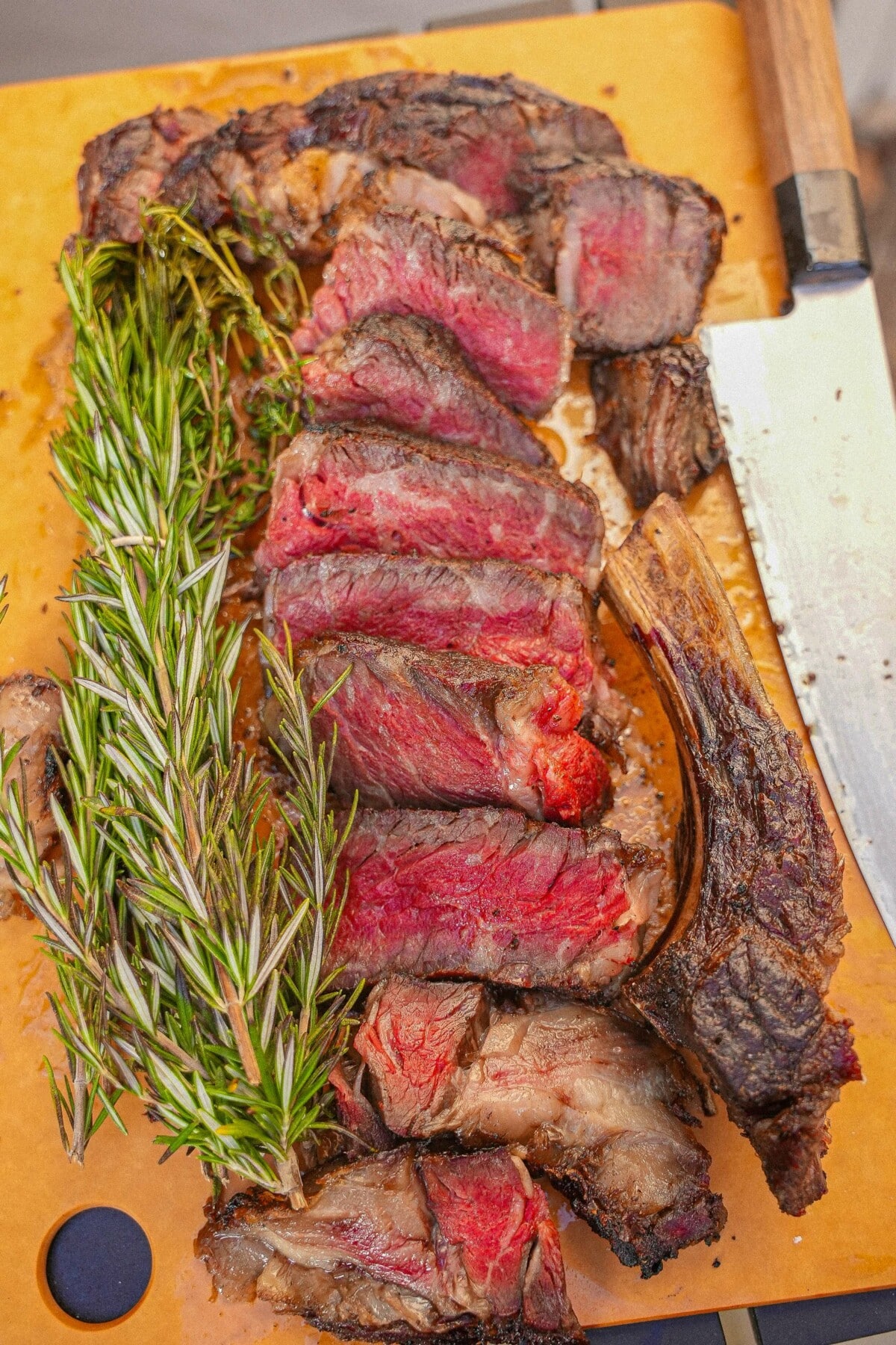 Carved ribeye steak on a cutting board.