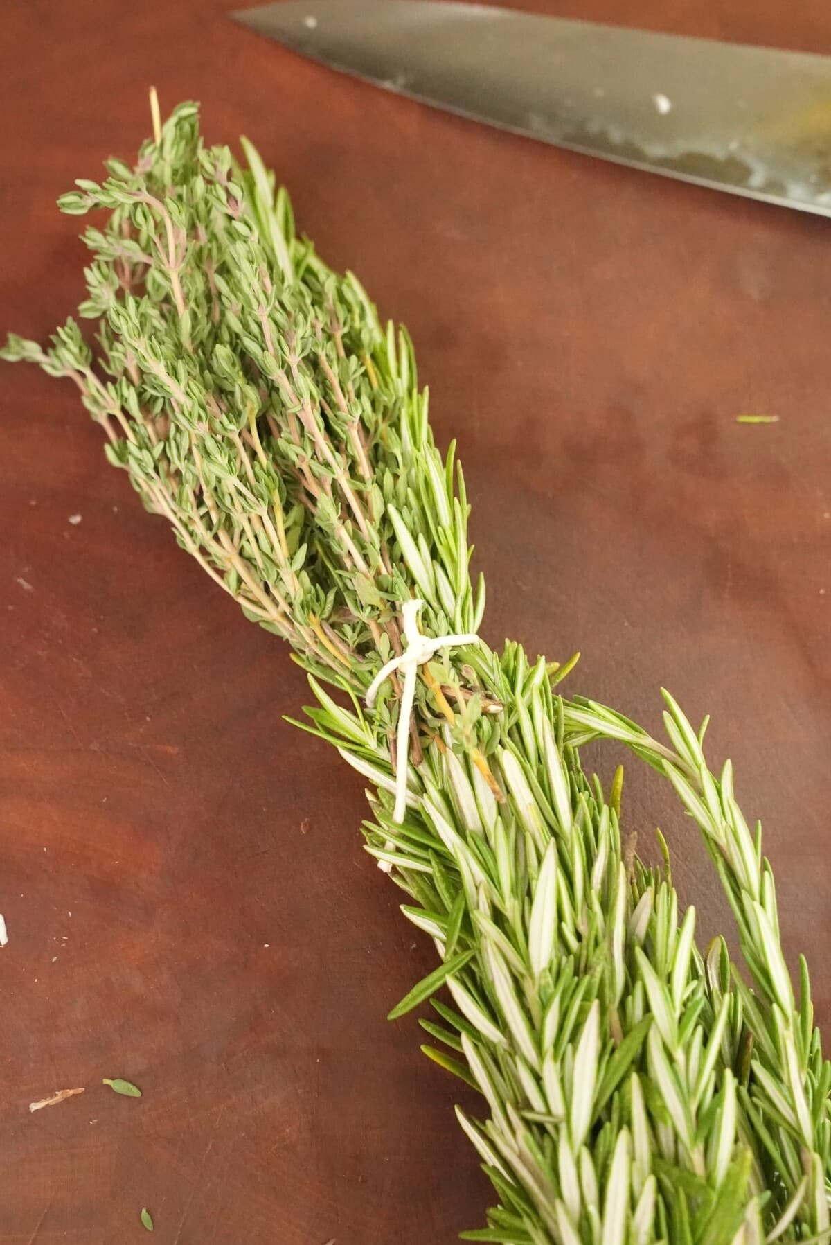 Sprigs of thyme and rosemary tied together with twine.