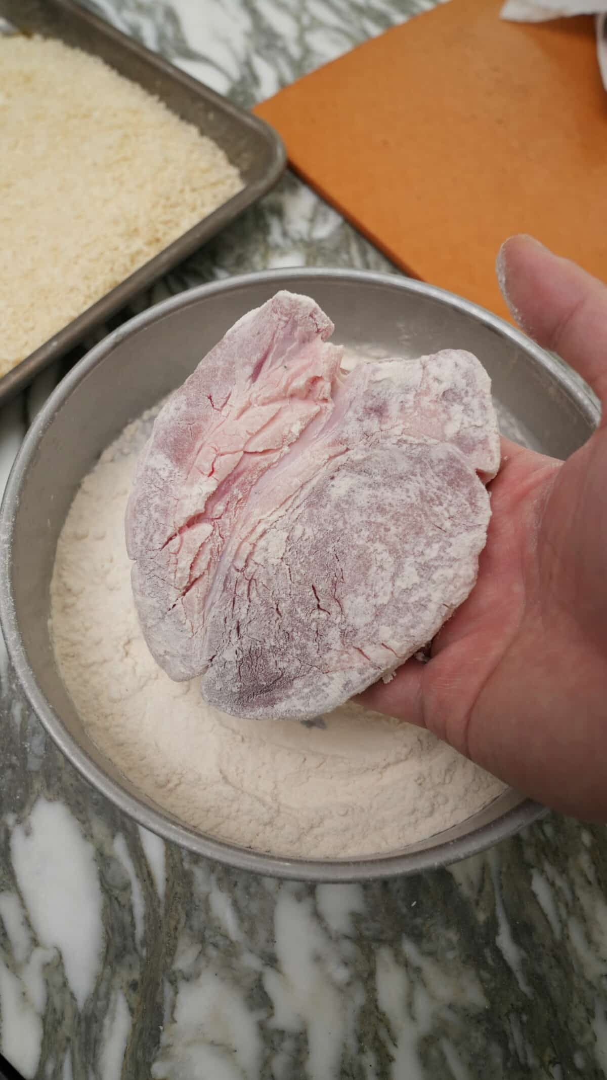 A pork loin dredged in plain all purpose flour.