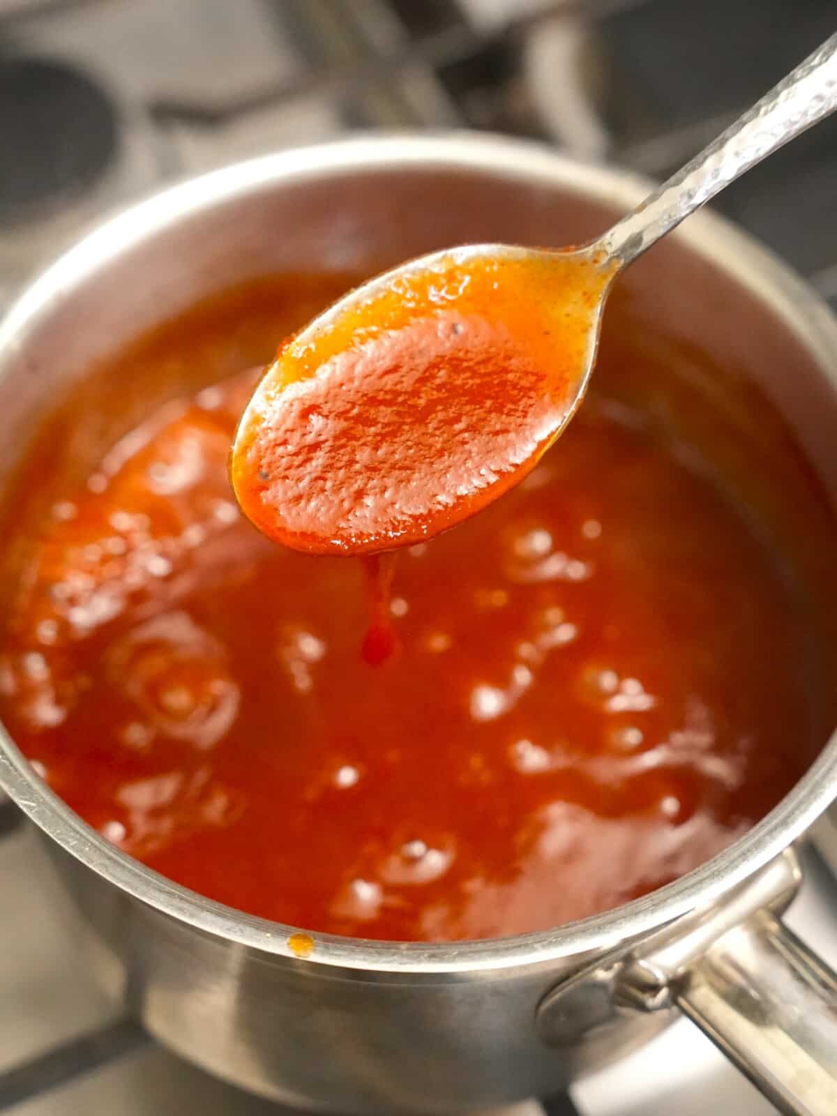 BBQ sauce reducing in a small saucepan.