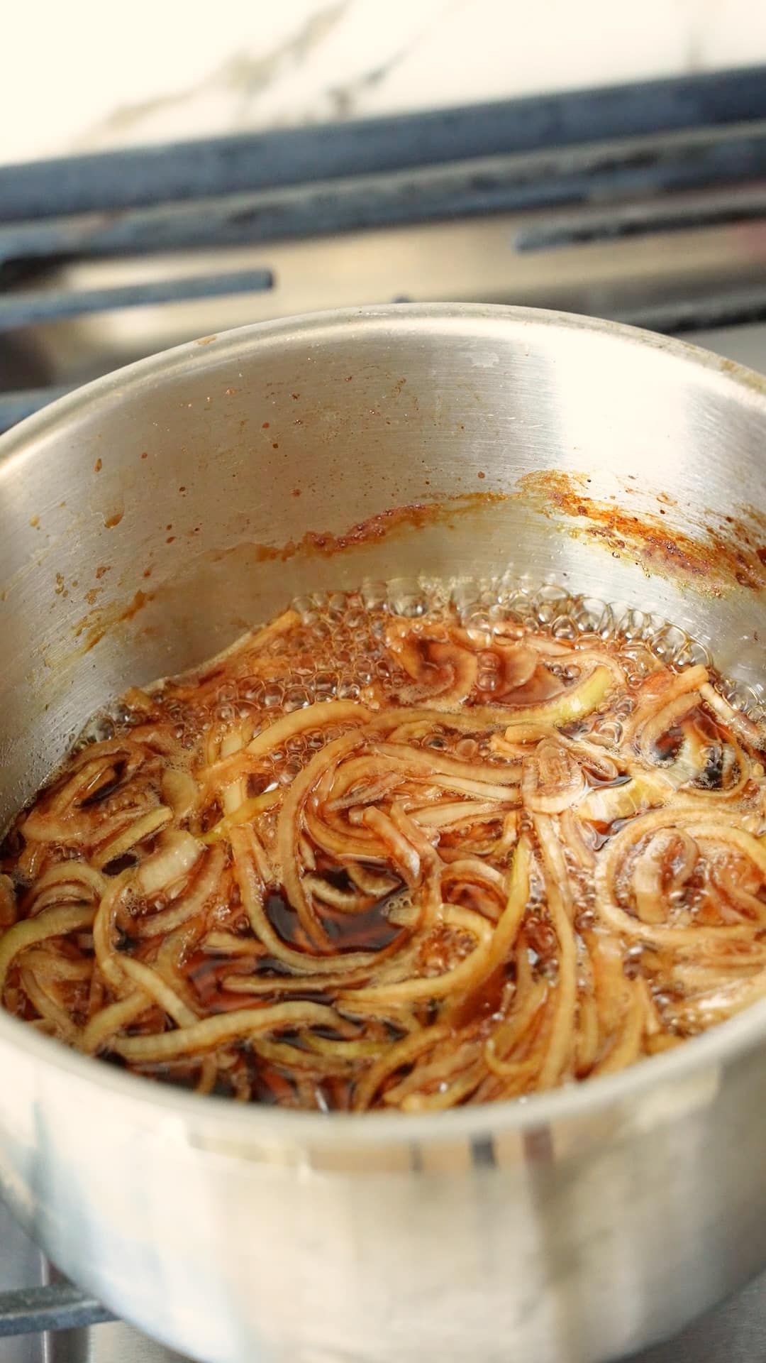 Onions simmering in gyudon sauce.