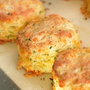 Cheddar biscuits freshly baked on a tray.