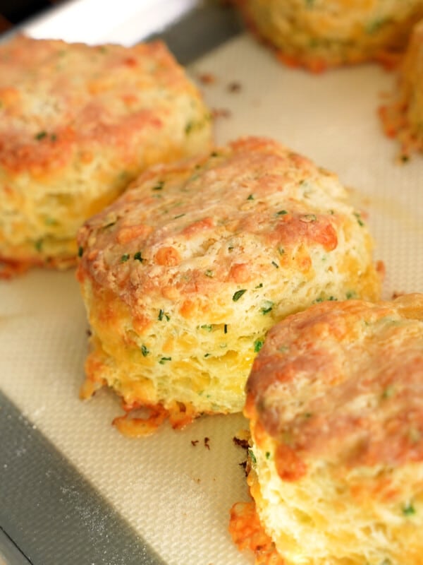 Cheddar biscuits freshly baked on a tray.