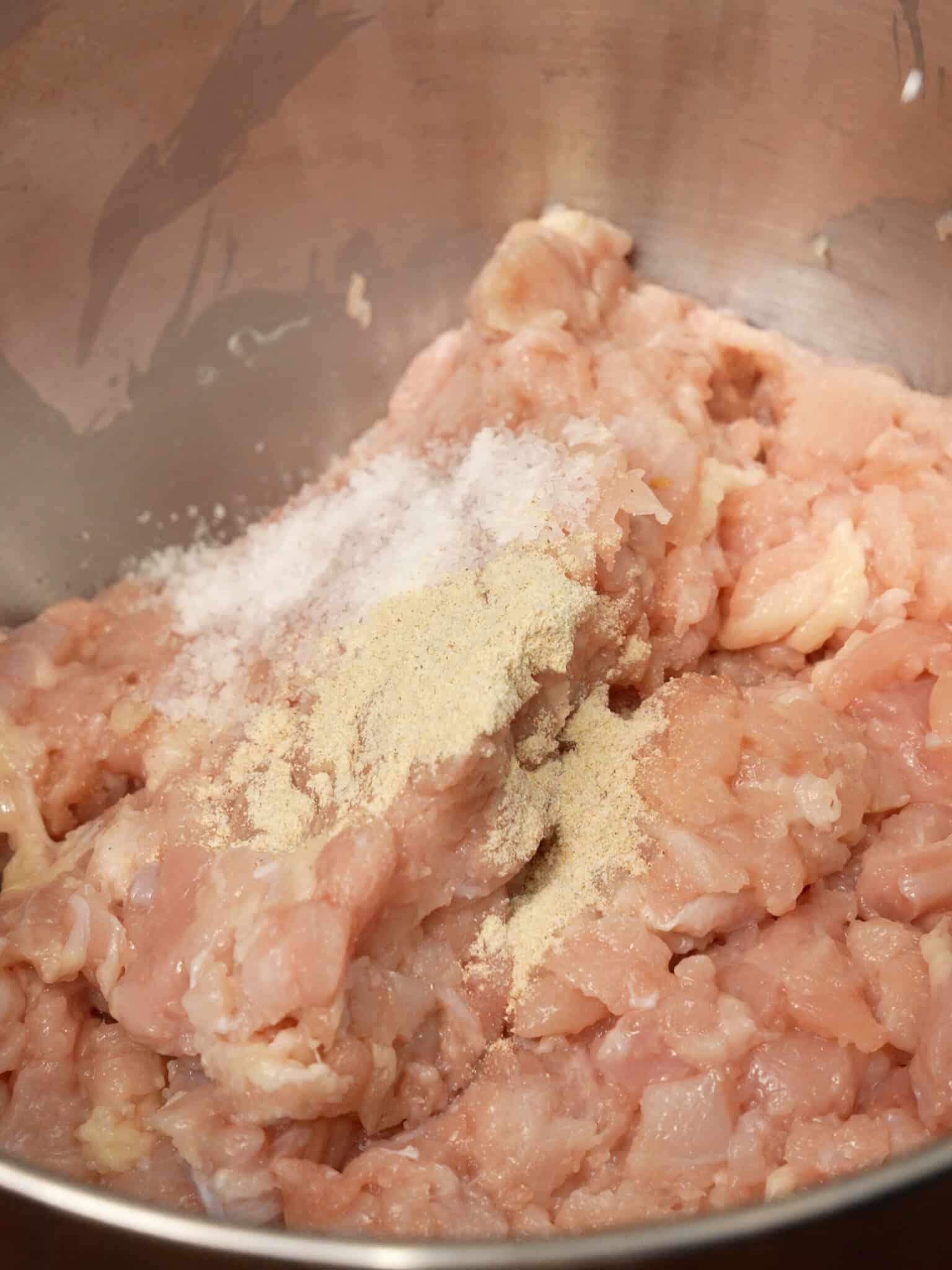 Minced chicken thigh being marinated in a bowl.