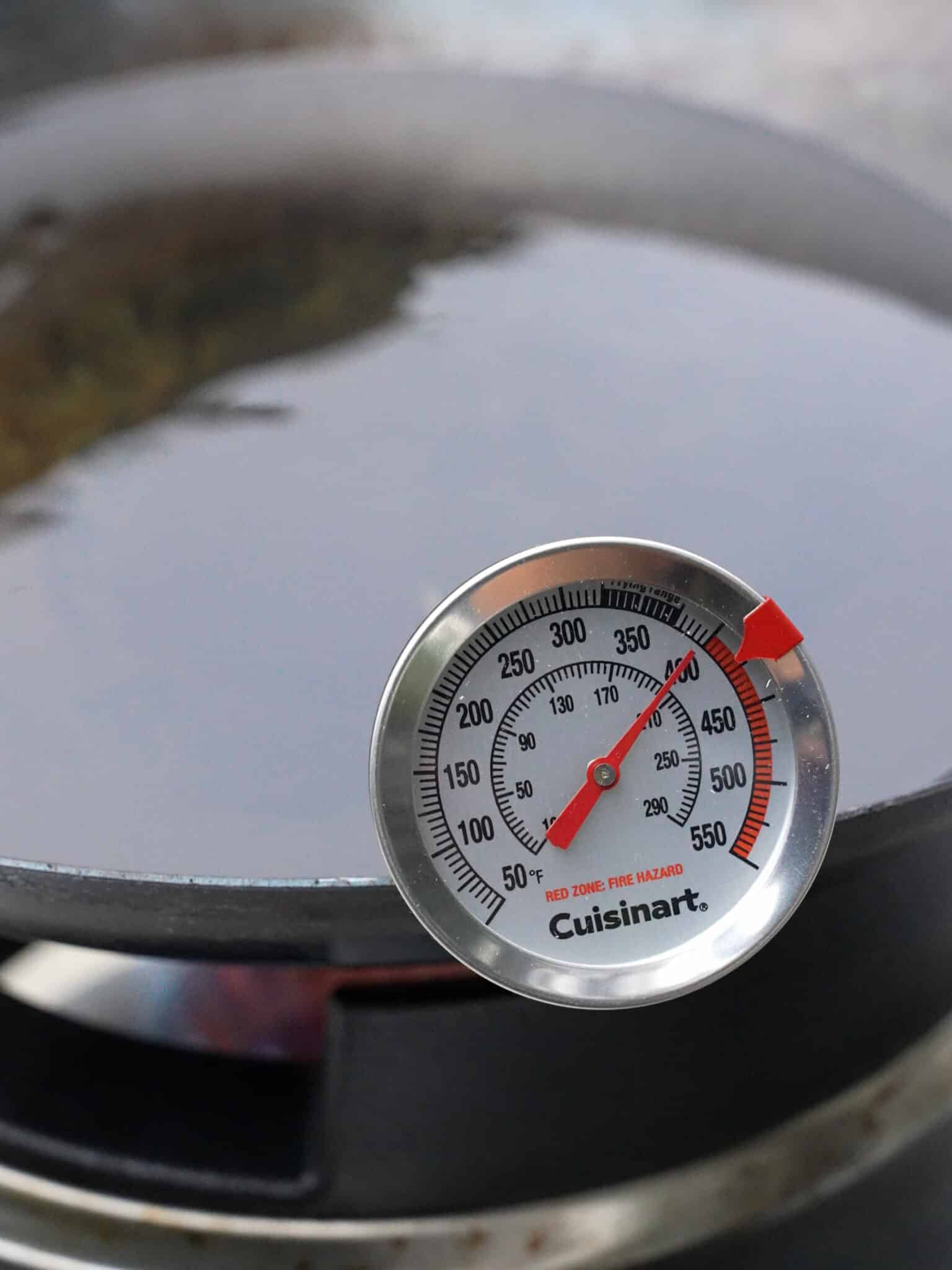 A thermometer showing 400°F oil in a wok.