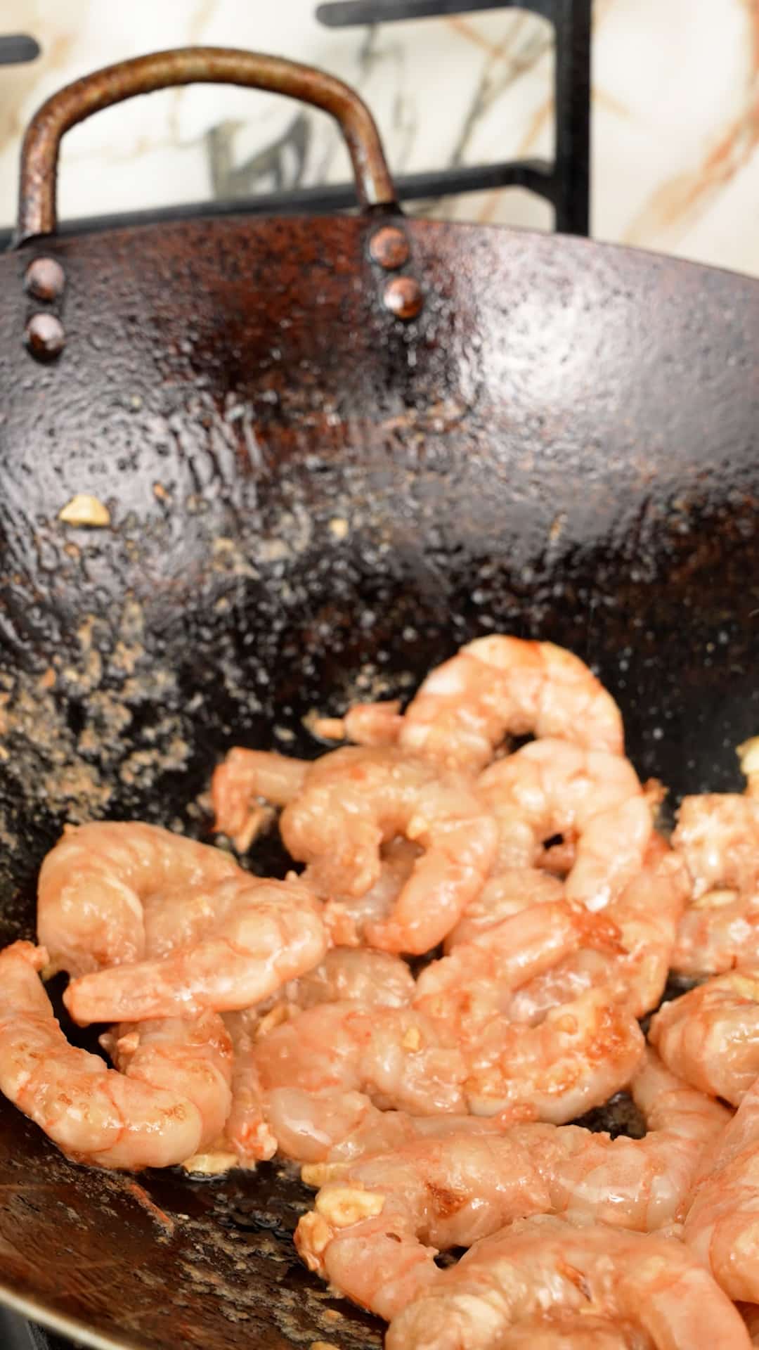 Cooking shrimp in a wok.